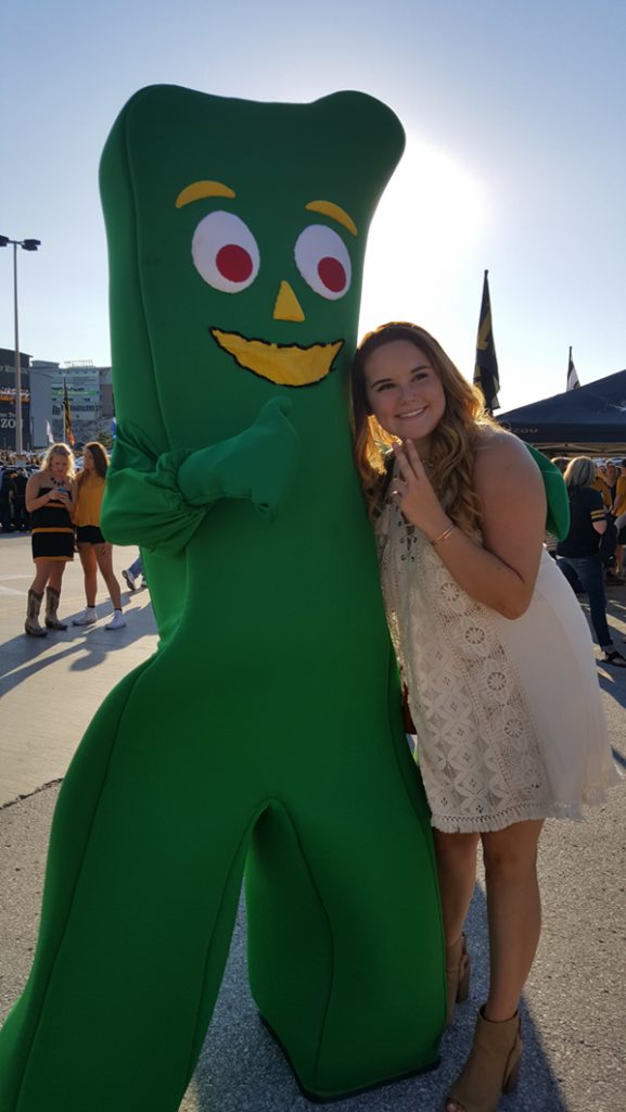 People posing with Gumby.