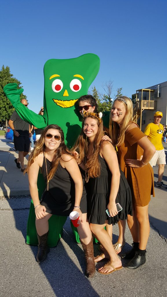 People posing with Gumby.