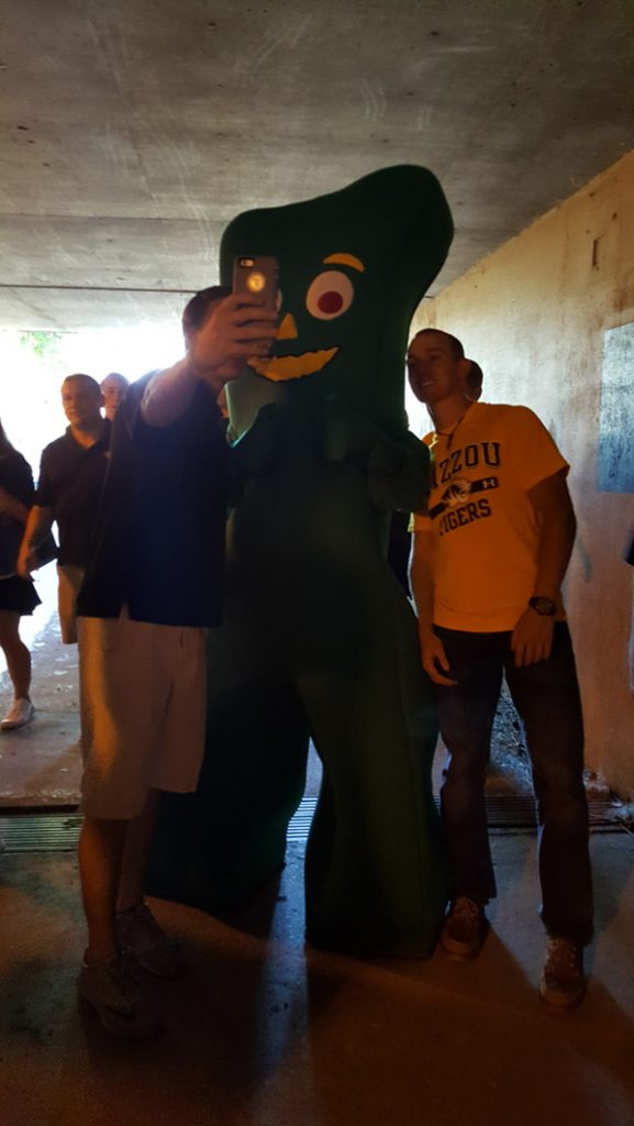 People posing with Gumby.