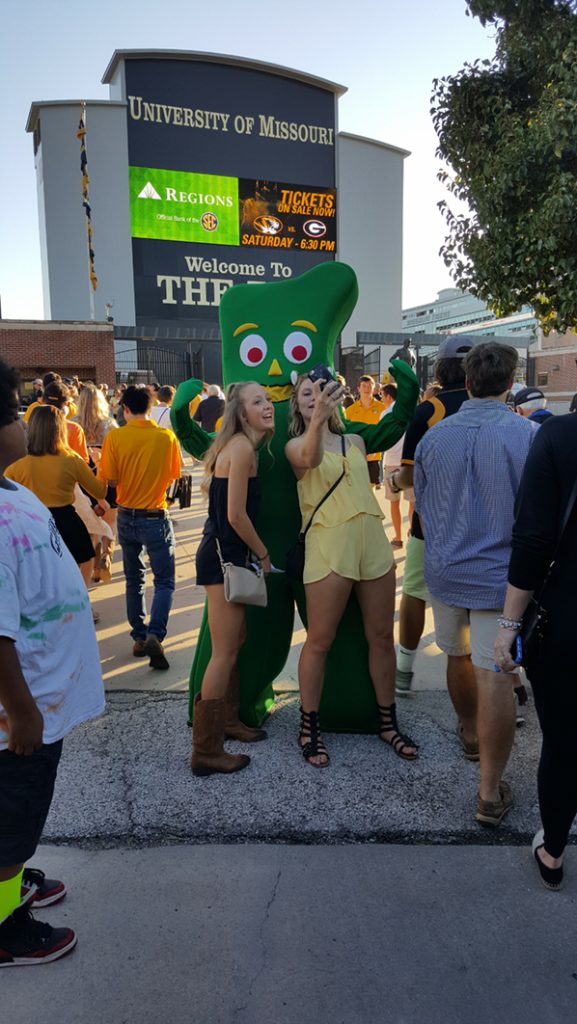 People posing with Gumby.