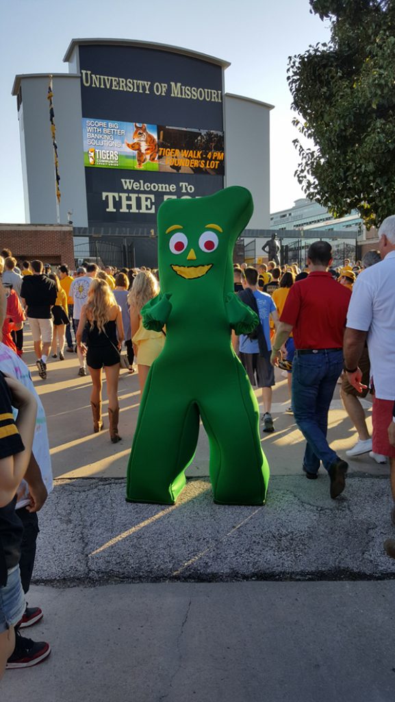 People posing with Gumby.