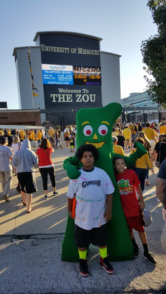 People posing with Gumby.