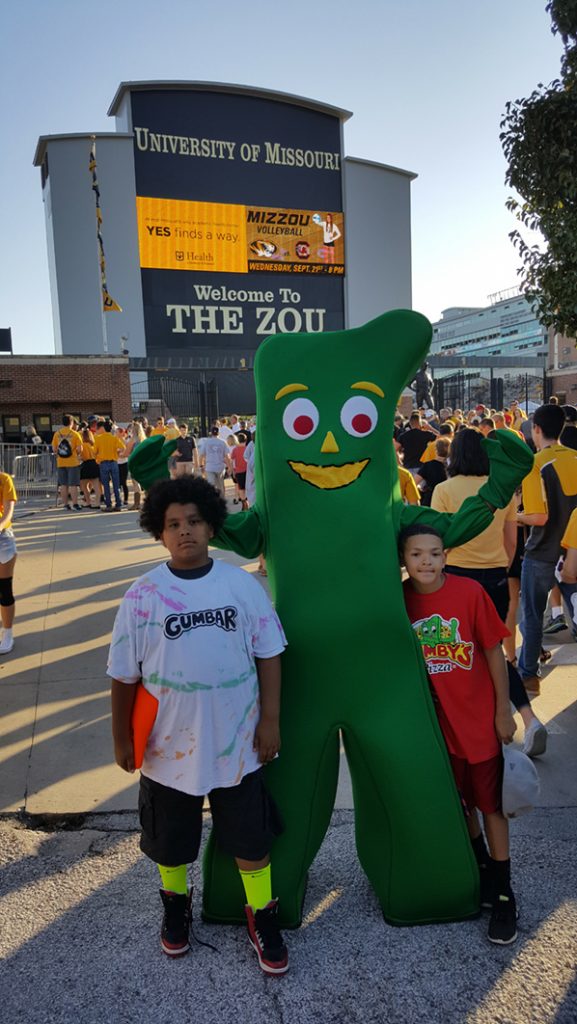 People posing with Gumby.