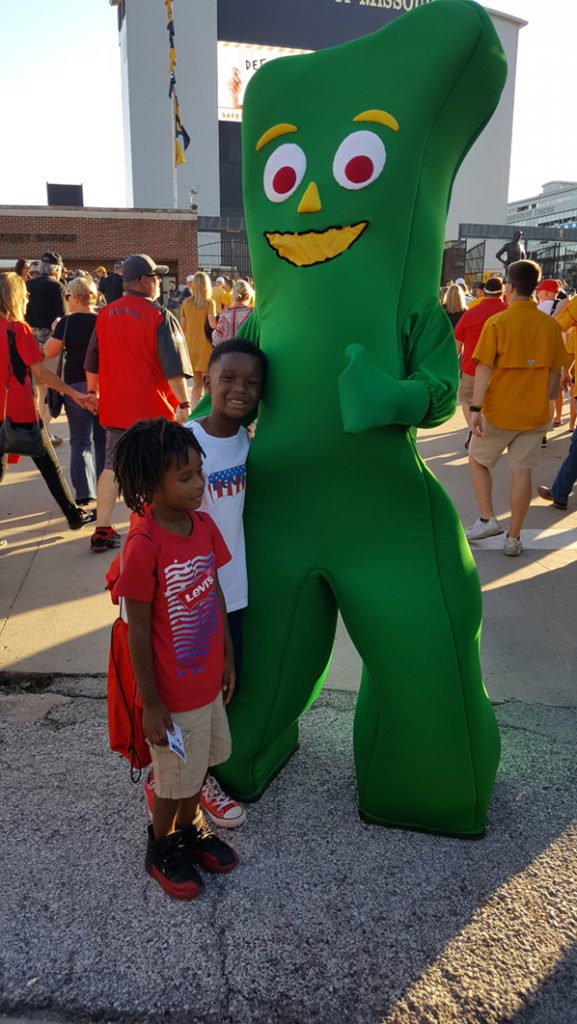People posing with Gumby.