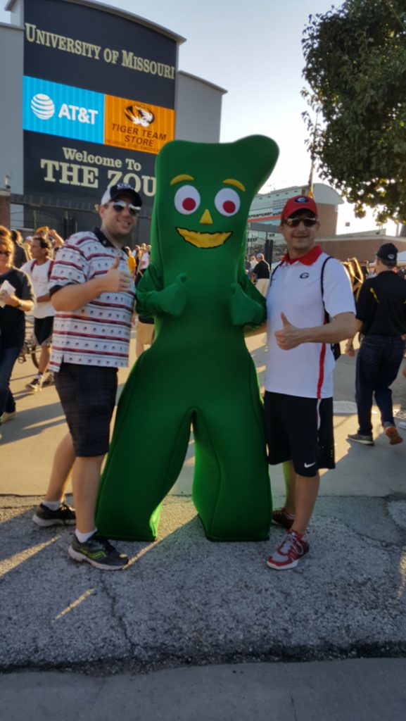 People posing with Gumby.