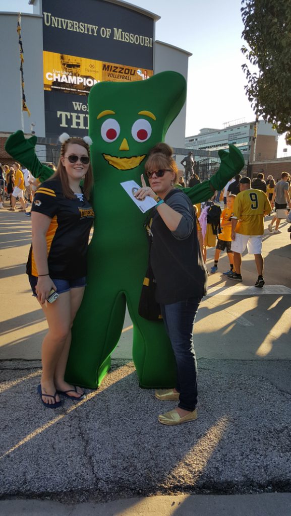 People posing with Gumby.