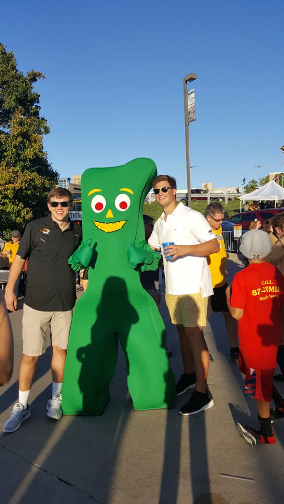 People posing with Gumby.