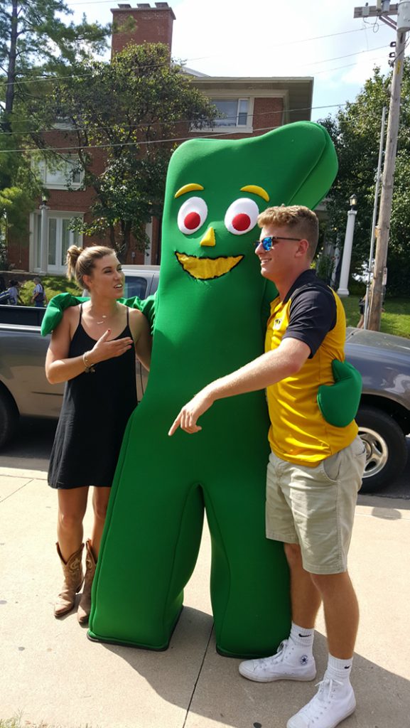 People posing with Gumby.