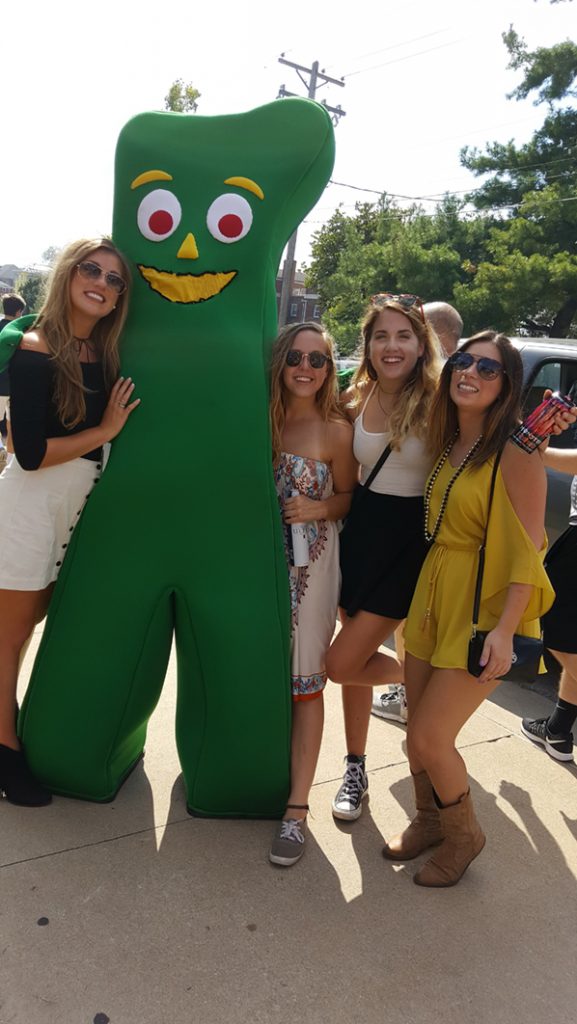 People posing with Gumby.