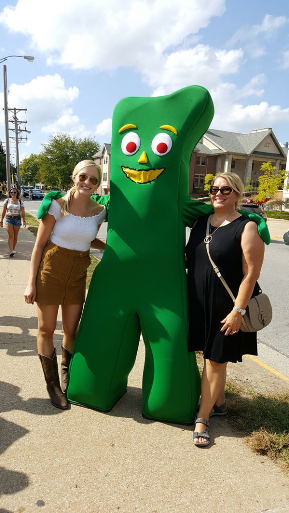 People posing with Gumby.