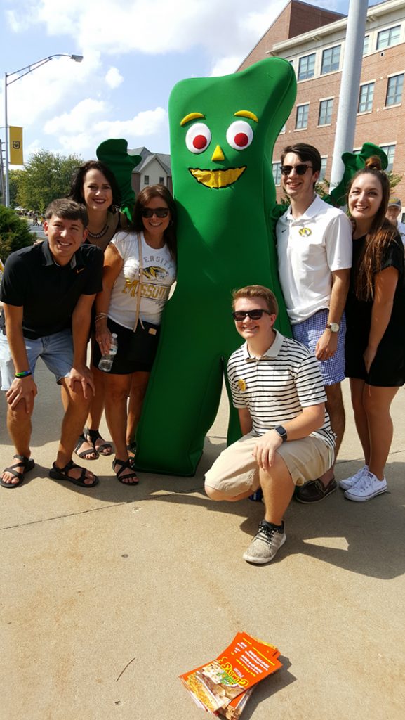 People posing with Gumby.