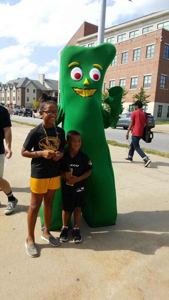 People posing with Gumby.