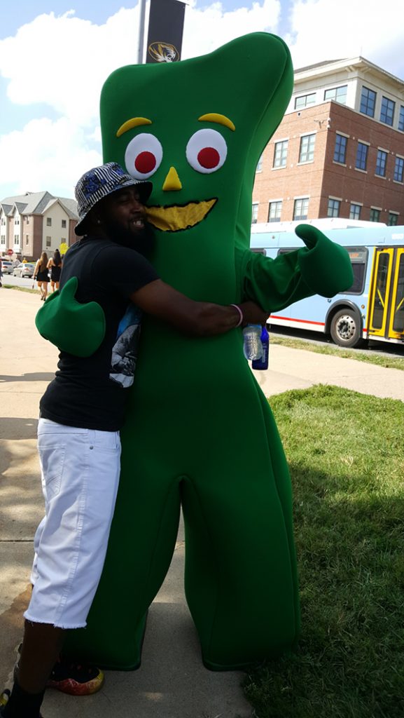People posing with Gumby.