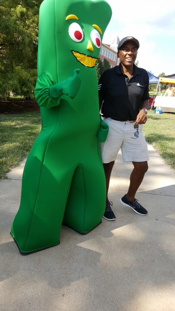 People posing with Gumby.