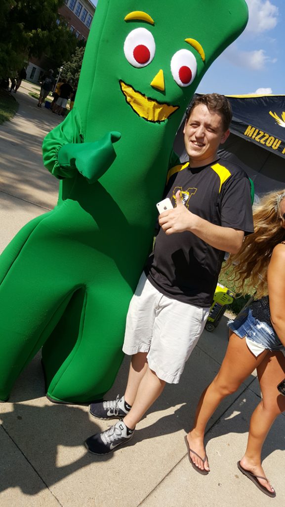 People posing with Gumby.