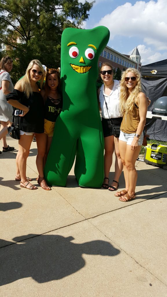 People posing with Gumby.