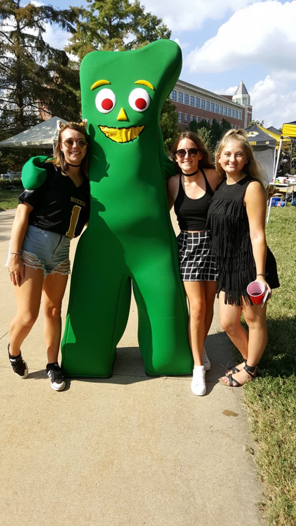 People posing with Gumby.