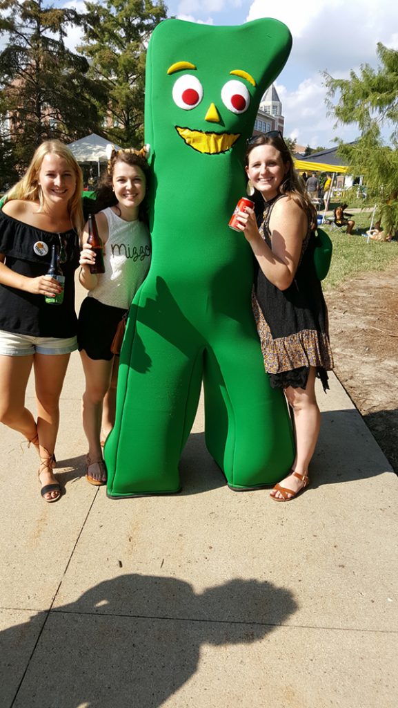 People posing with Gumby.