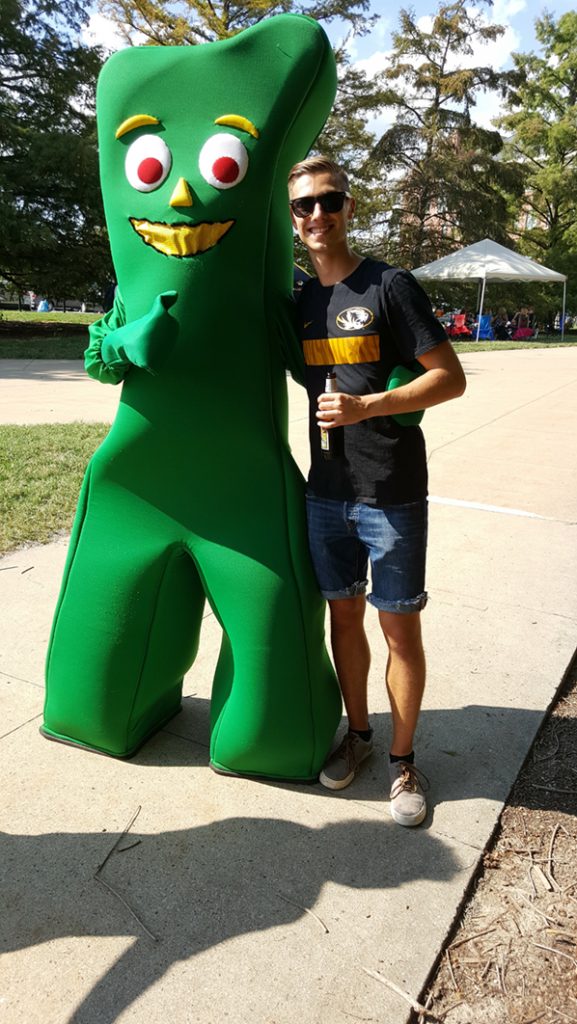 People posing with Gumby.