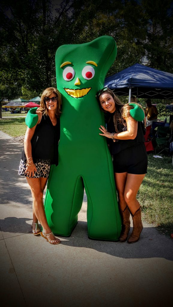 People posing with Gumby.