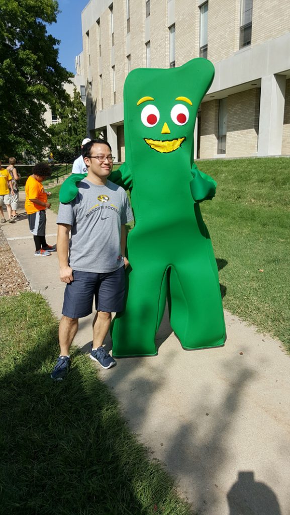 People posing with Gumby.