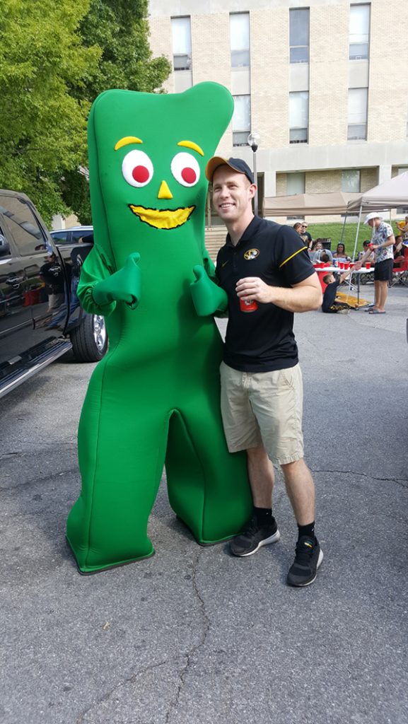 People posing with Gumby.
