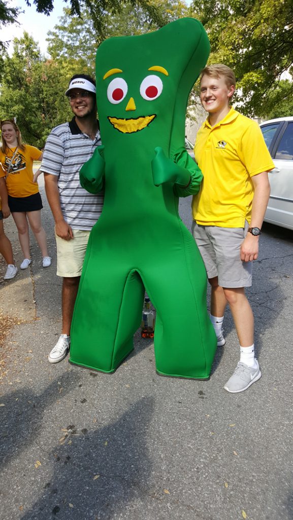 People posing with Gumby.