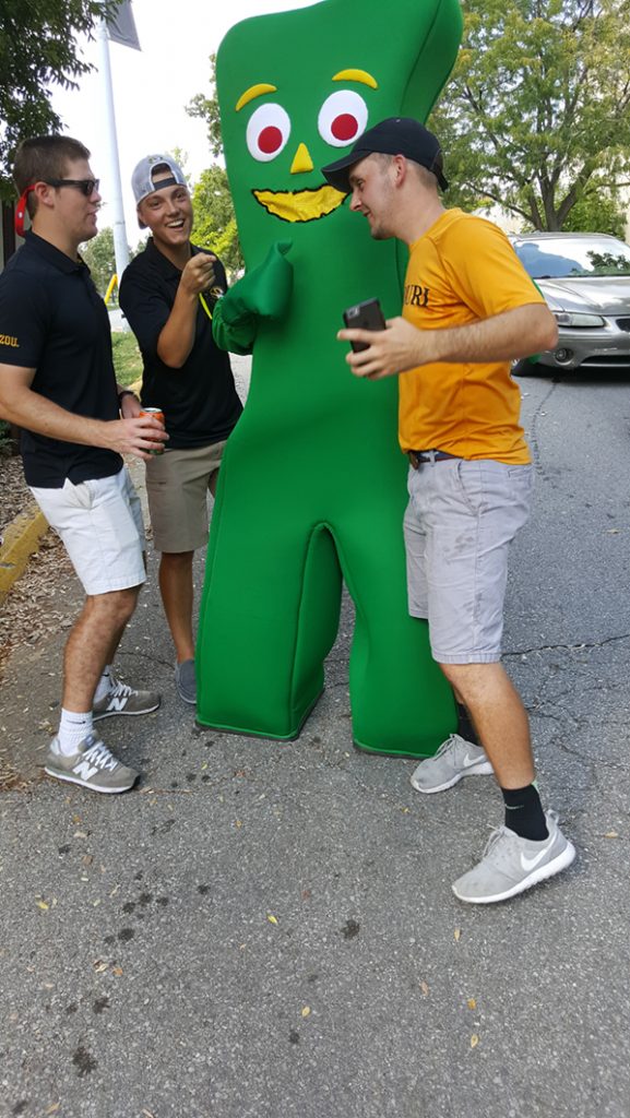People posing with Gumby.