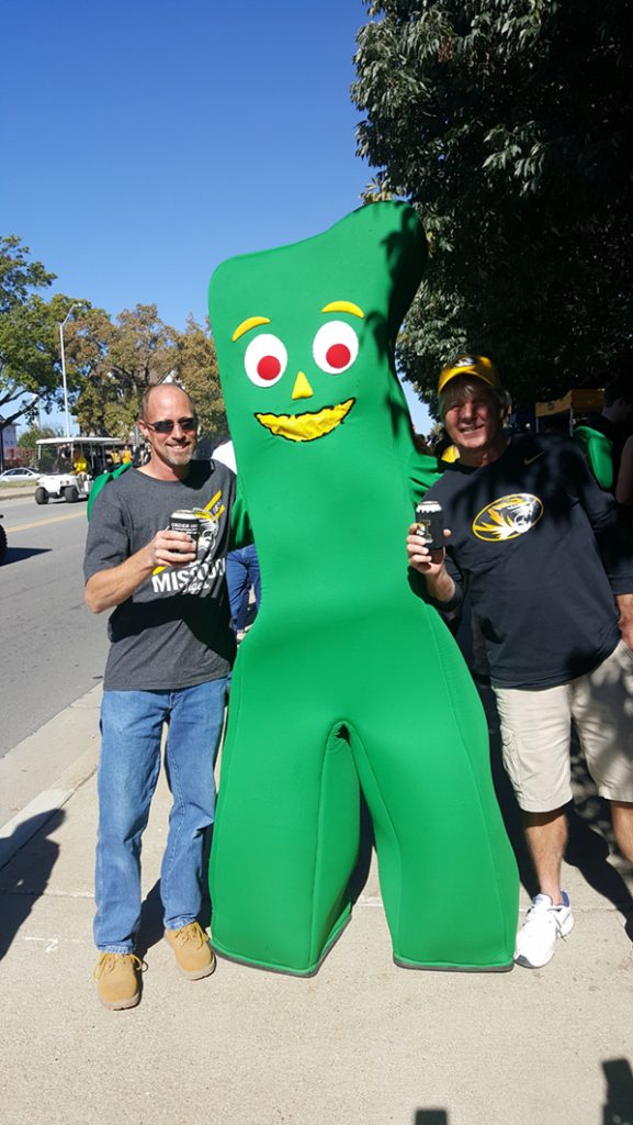 People posing with Gumby.