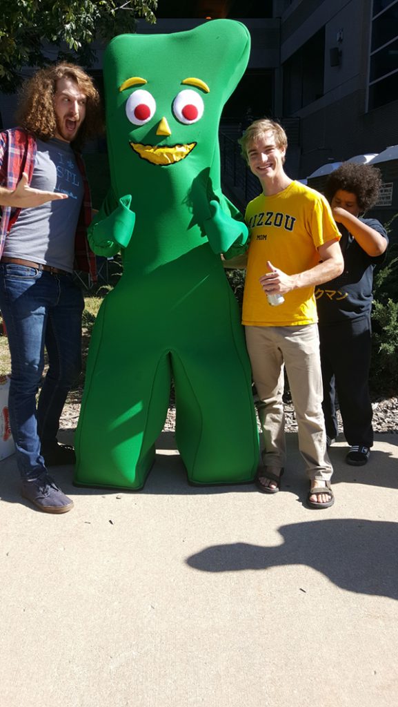 People posing with Gumby.