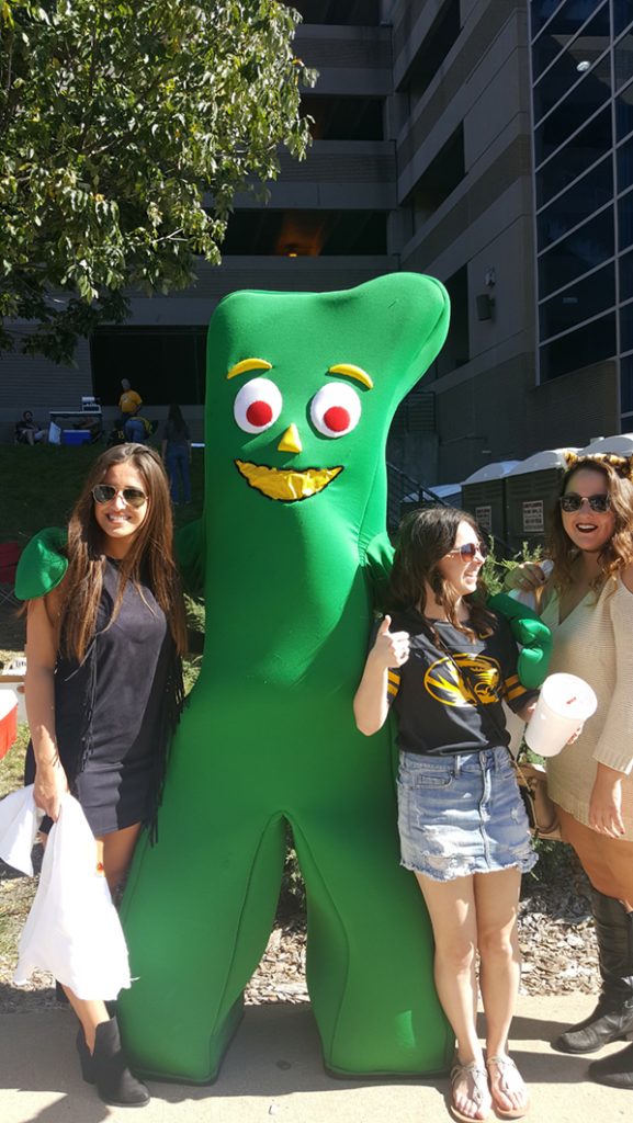 People posing with Gumby.