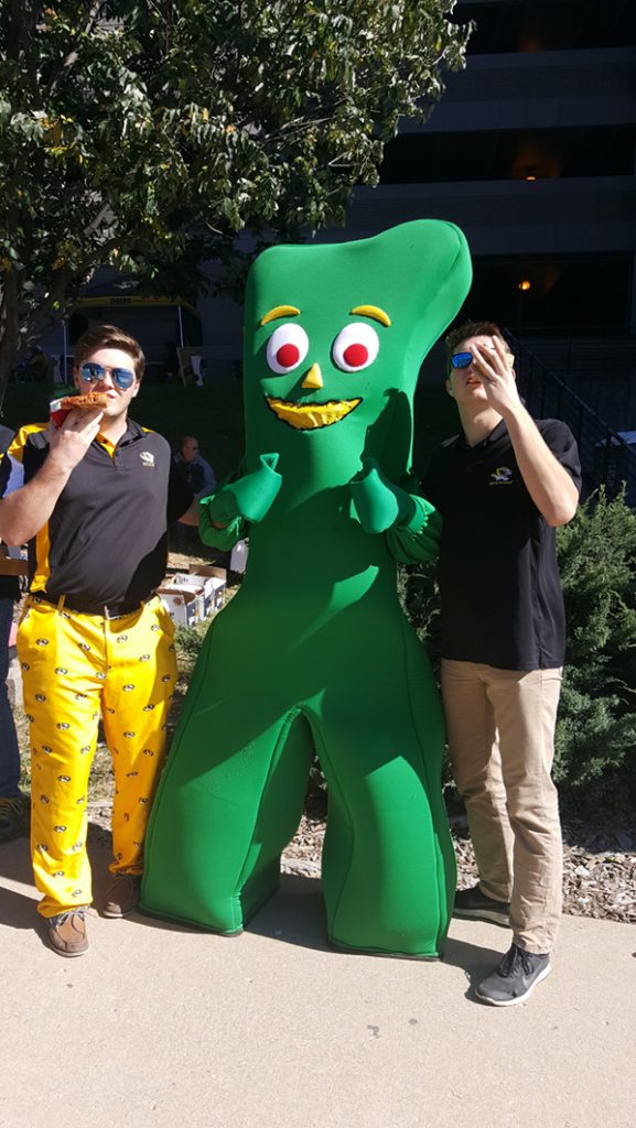 People posing with Gumby.