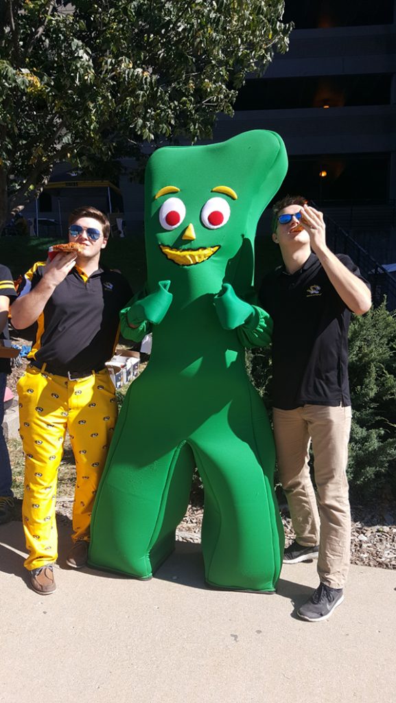 People posing with Gumby.