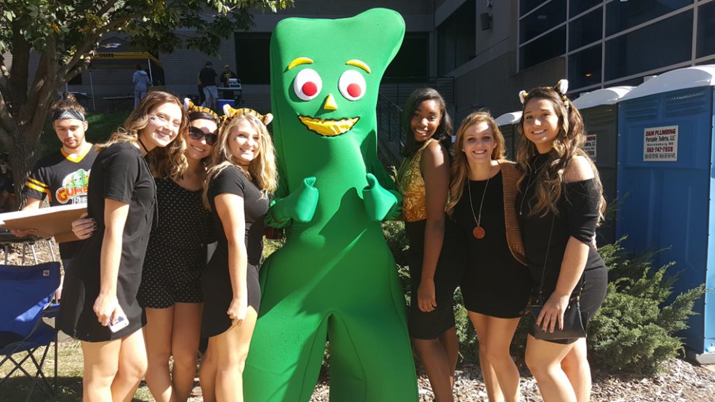 People posing with Gumby.