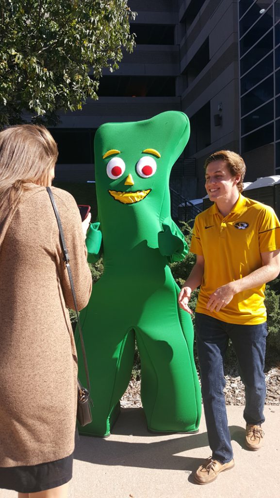 People posing with Gumby.