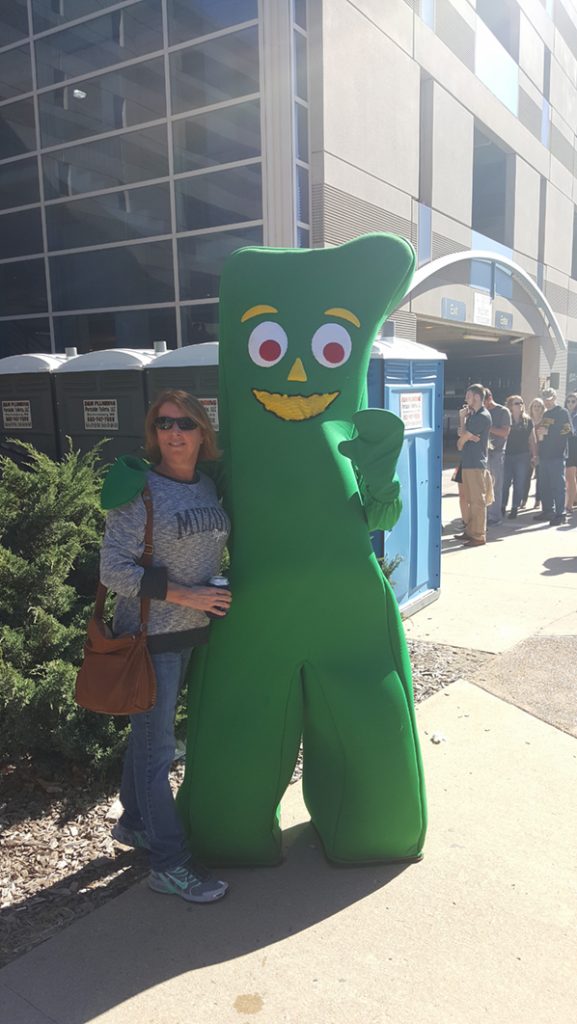 People posing with Gumby.